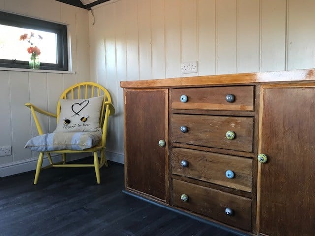 Wooden furniture inside the shepherd’s hut
