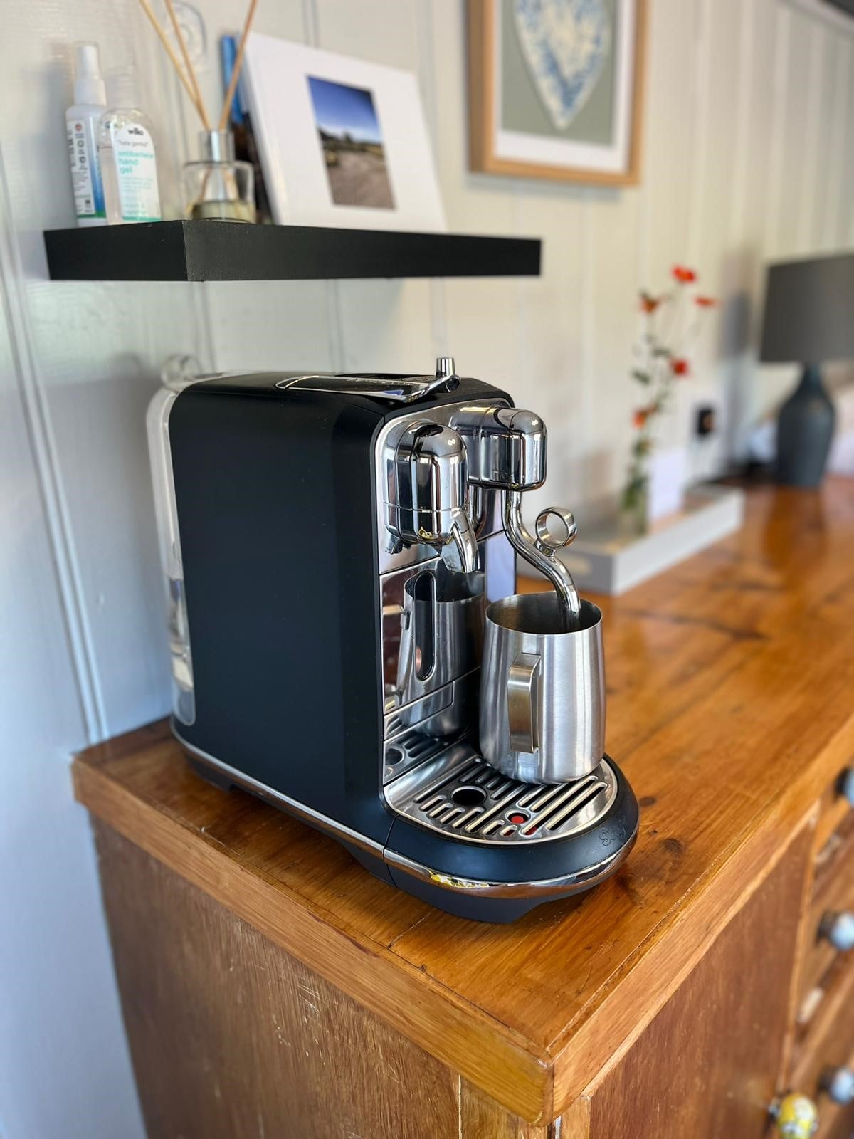 Coffee machine on a wooden dresser inside Mabel